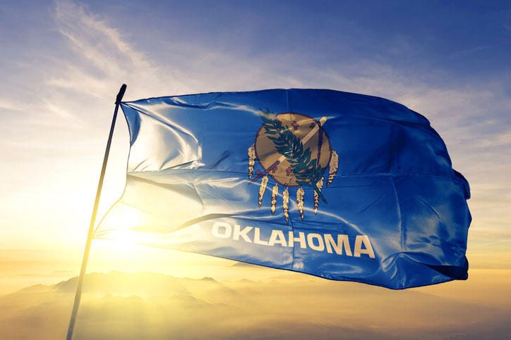 oklahoma state flag in the mist and sun