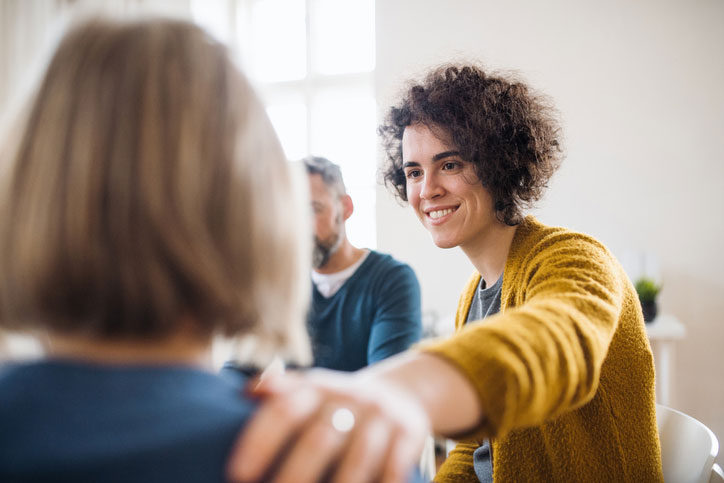 counselor comforting patient in group