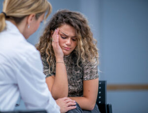 young woman in therapy with counselor