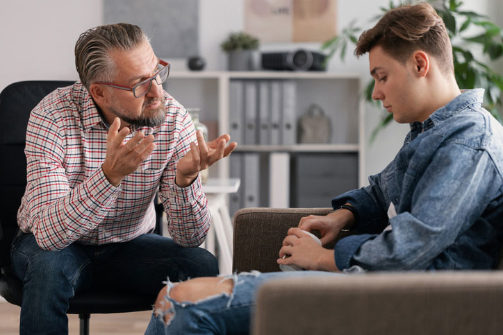 young teen and counselor in office