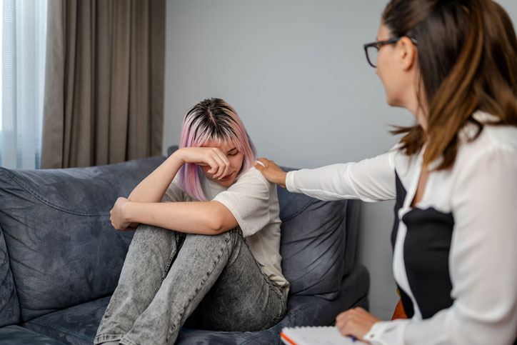 counselor consoling teen girl