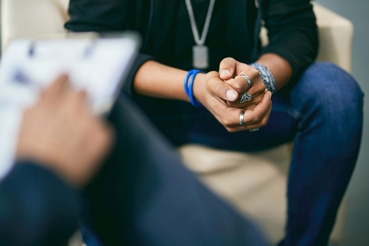 distressed young man talking with counselor