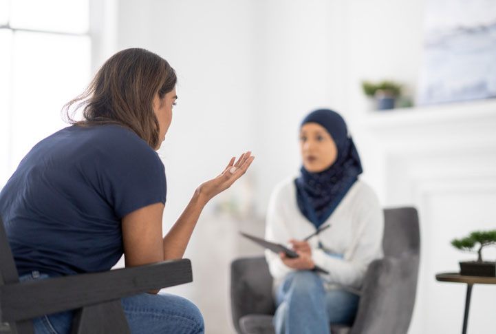 muslim therapist in session with young woman