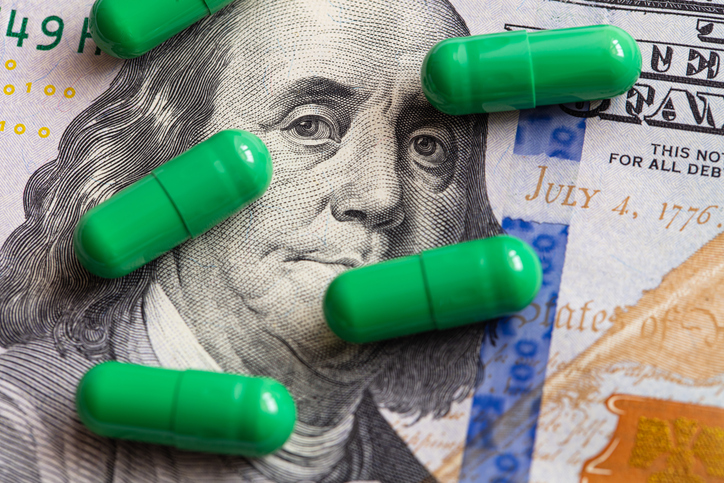 green pills on 100 dollar bill