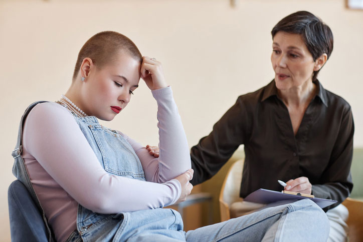 depressed teen girl talking to counselor