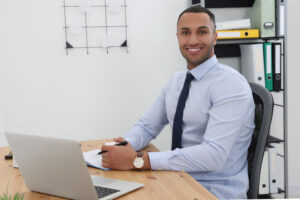 young man at desk in office