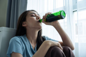 young, depressed woman drinking