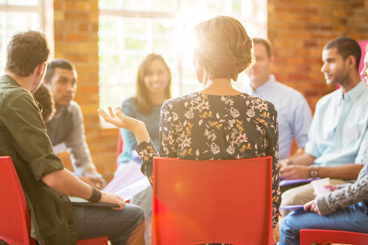 woman speaking in group therapy