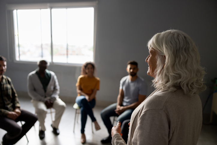 Mental health professional talking in a group therapy session