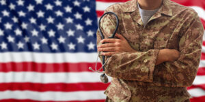 soldier in front of flag