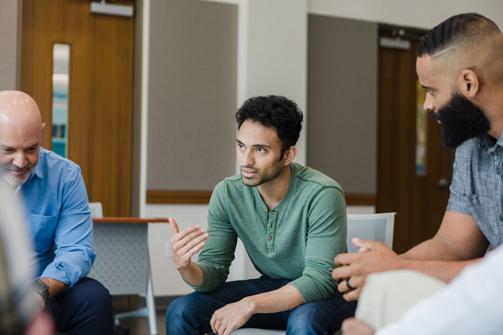 man talking with group