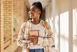 young woman walking through corridor