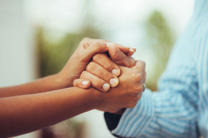 holding the patients hand