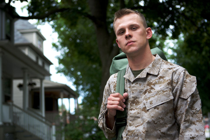 male soldier carrying backpack