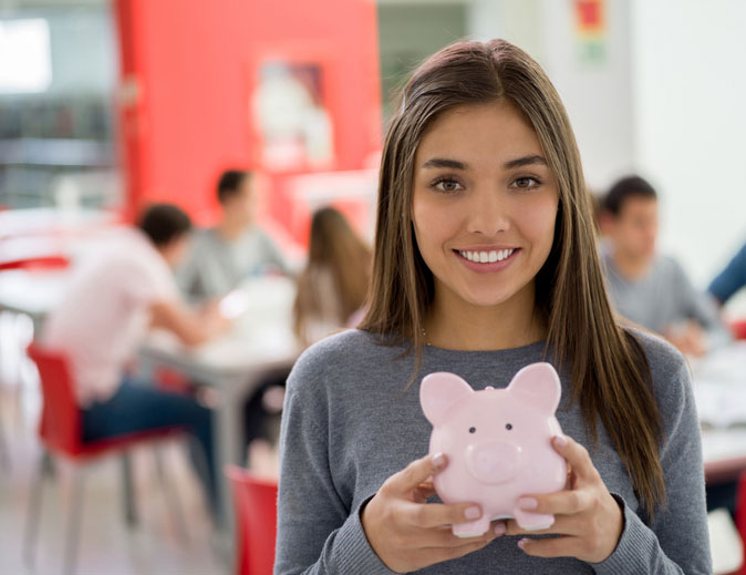 saving money in her piggy bank