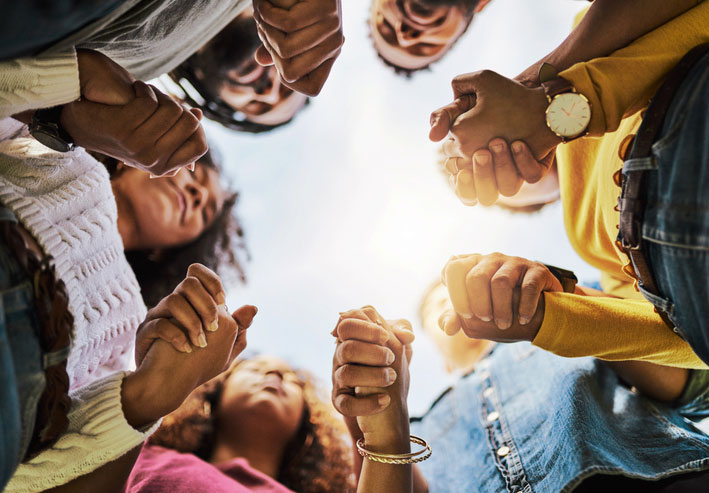 looking up at small group holding hands