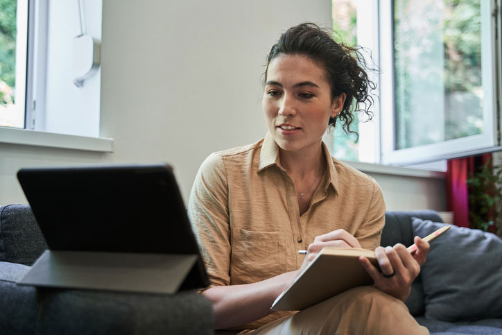 female remote peer support specialist on laptop