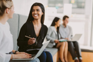Graduate students in substance abuse counseling program engaged in collaborative discussion during internship preparation seminar, with diverse professionals networking in modern classroom setting