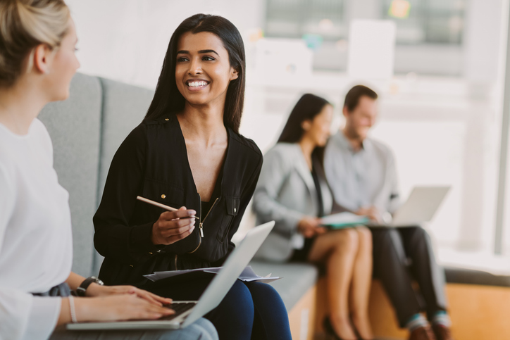 Graduate students in substance abuse counseling program engaged in collaborative discussion during internship preparation seminar, with diverse professionals networking in modern classroom setting